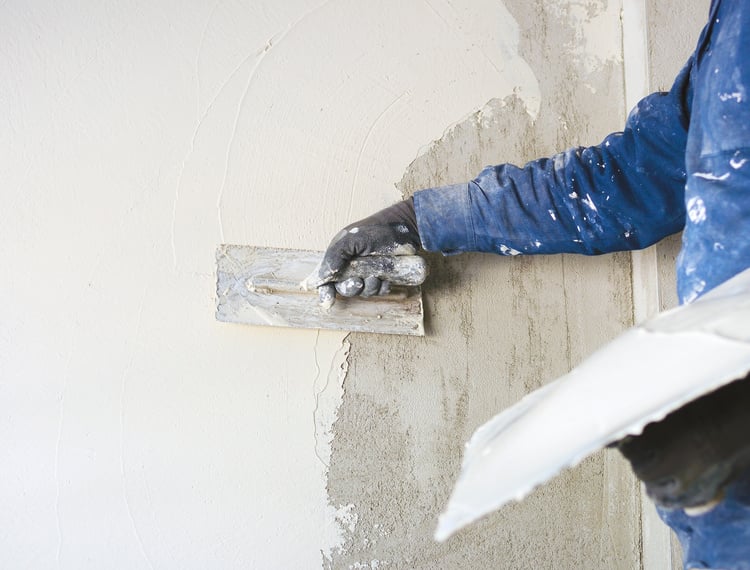 worker plastering tool plaster marble on interior plaster rough